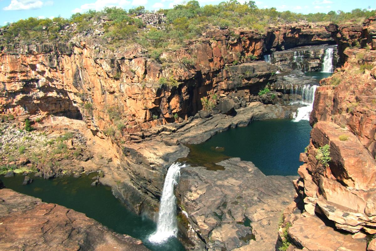 triple waterfalls over huge expanse of granite cliffs at Mitchell Falls