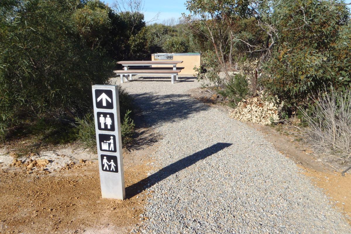 Picnic table and barbeque facilities at Four Mile Campground