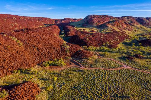 View of large red mounds of rocks with blue skies