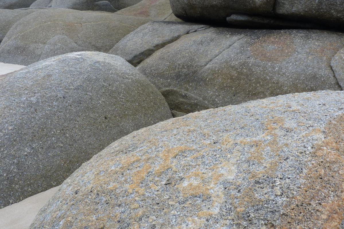 close up of granite boulders in sand