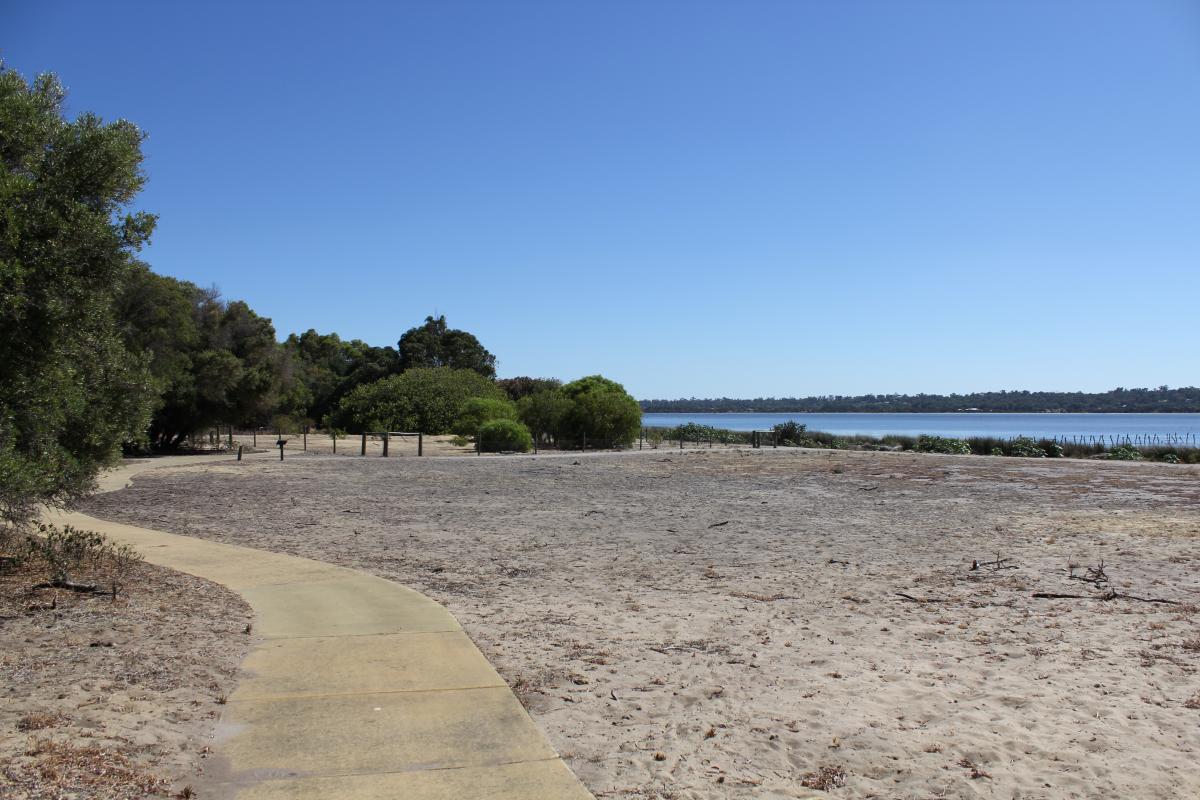 the walk trail that is on the foreshore of the estuary and trees on the left