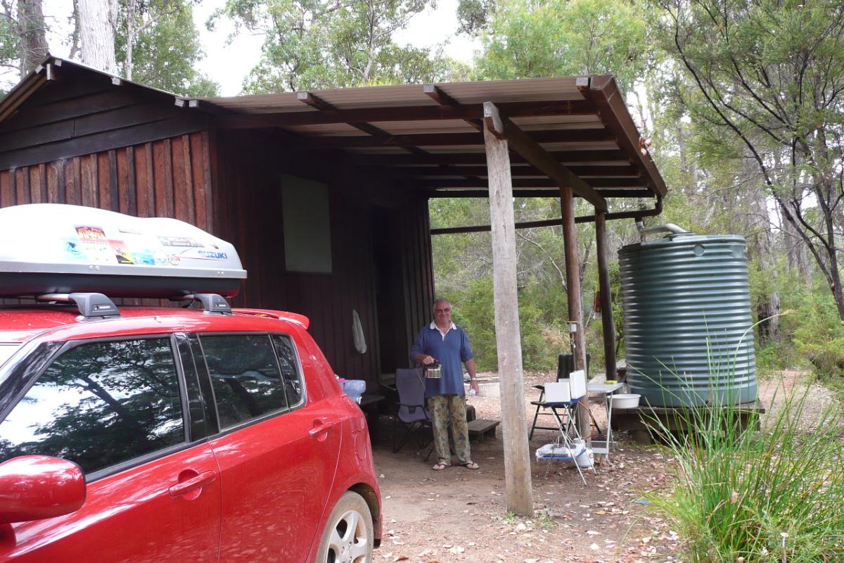 red vehicle backed up to the hut at the fernhook falls campground