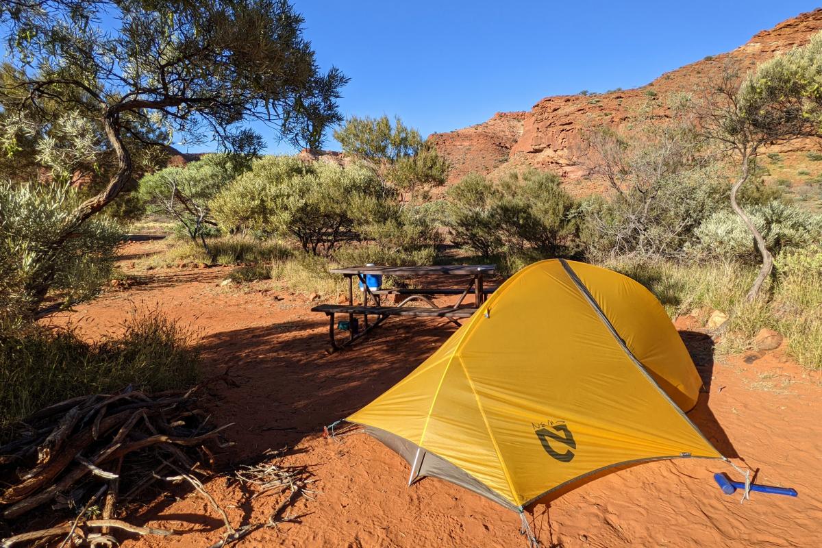 small orange tent on the red soil at Temple Gorge Campground