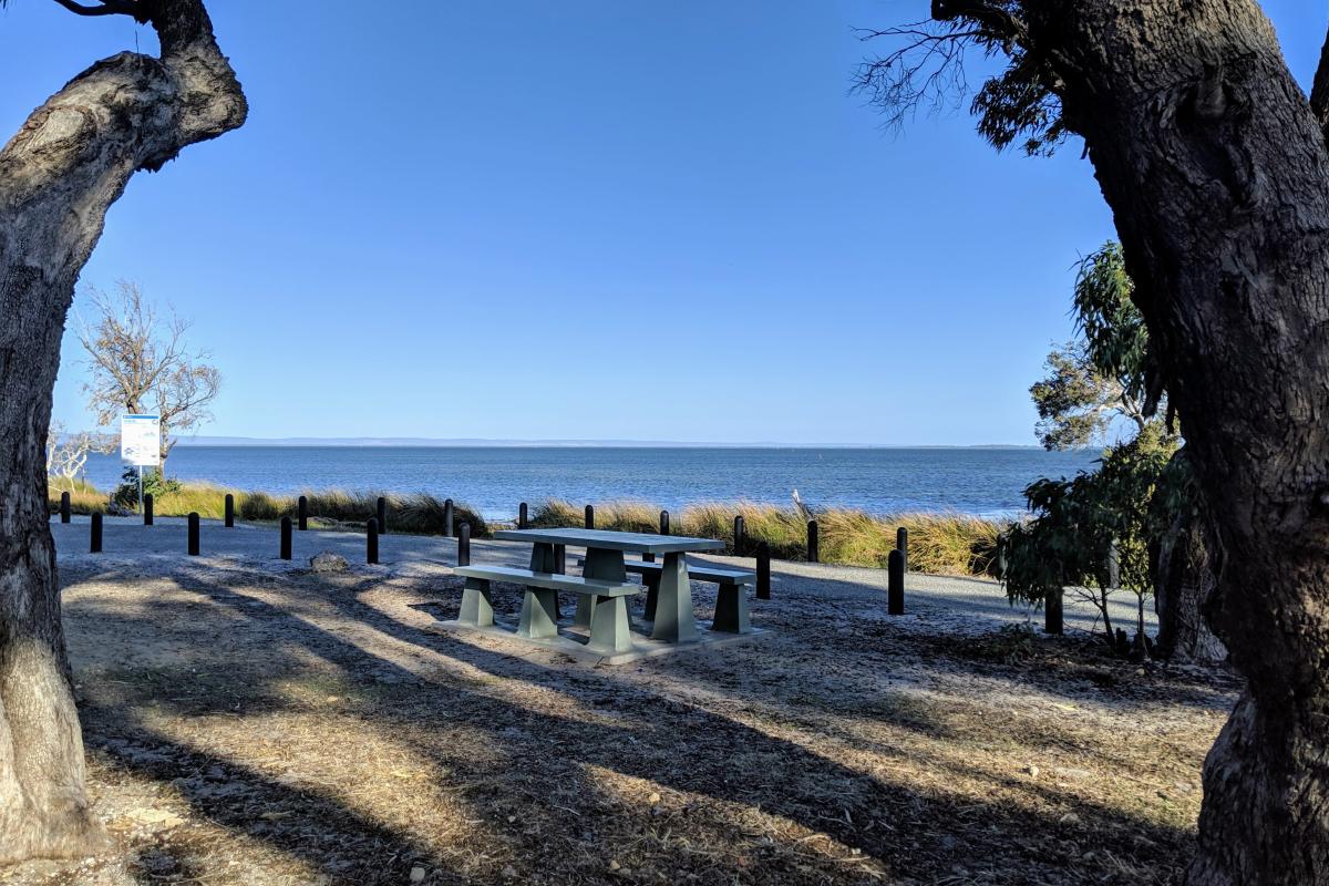 Picnic bench at Len Howard picnic area with views over the estuary